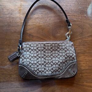 Coach signature jacquard fabric wristlet in brown and tan.